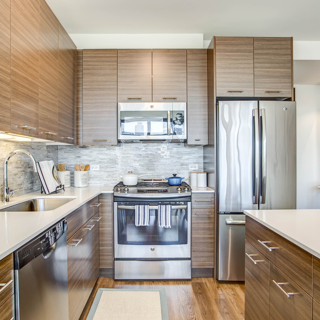 Next Apartments - Kitchen with Dishwasher, Refrigerator, and Microwave
